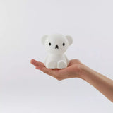 A Miffy Boris Bear Night Light (15cm), crafted from BPA-free silicone, is held in a person's hand against a plain background.