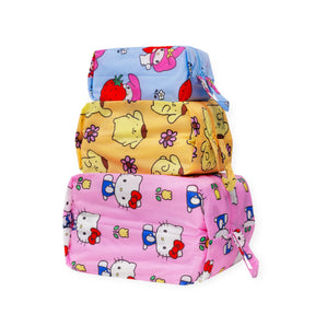 Three rectangular zippered pouches with colorful Hello Kitty cartoon prints on blue, yellow, and pink backgrounds make up the limited edition Hello Kitty x Baggu Storage & Travel Set by Baggu.