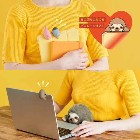 Two playful Funbarus Hippers mini figures perched on tablet and laptop edges held by person in yellow sweater