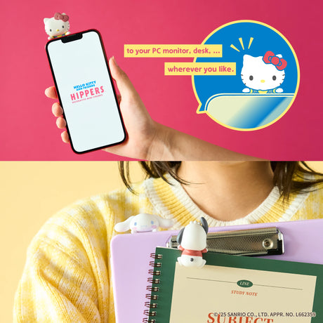 Hand holding phone with small Hello Kitty figurine on top and two character clips attached to notebooks on yellow background