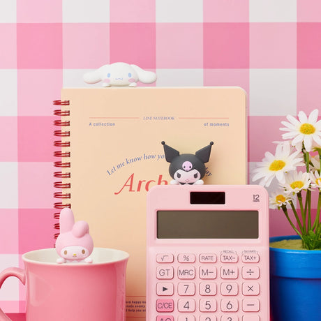 Hello Kitty Hippers mini figures beside notebook and calculator