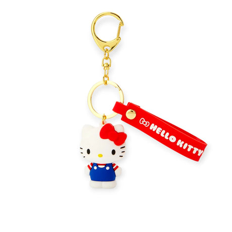 The Hello Kitty 3D Figure - Keychain displays Hello Kitty in a blue outfit with a red bow, featuring a red strap with "Hello Kitty" text and a gold-tone clip, ideal for fans of all ages.