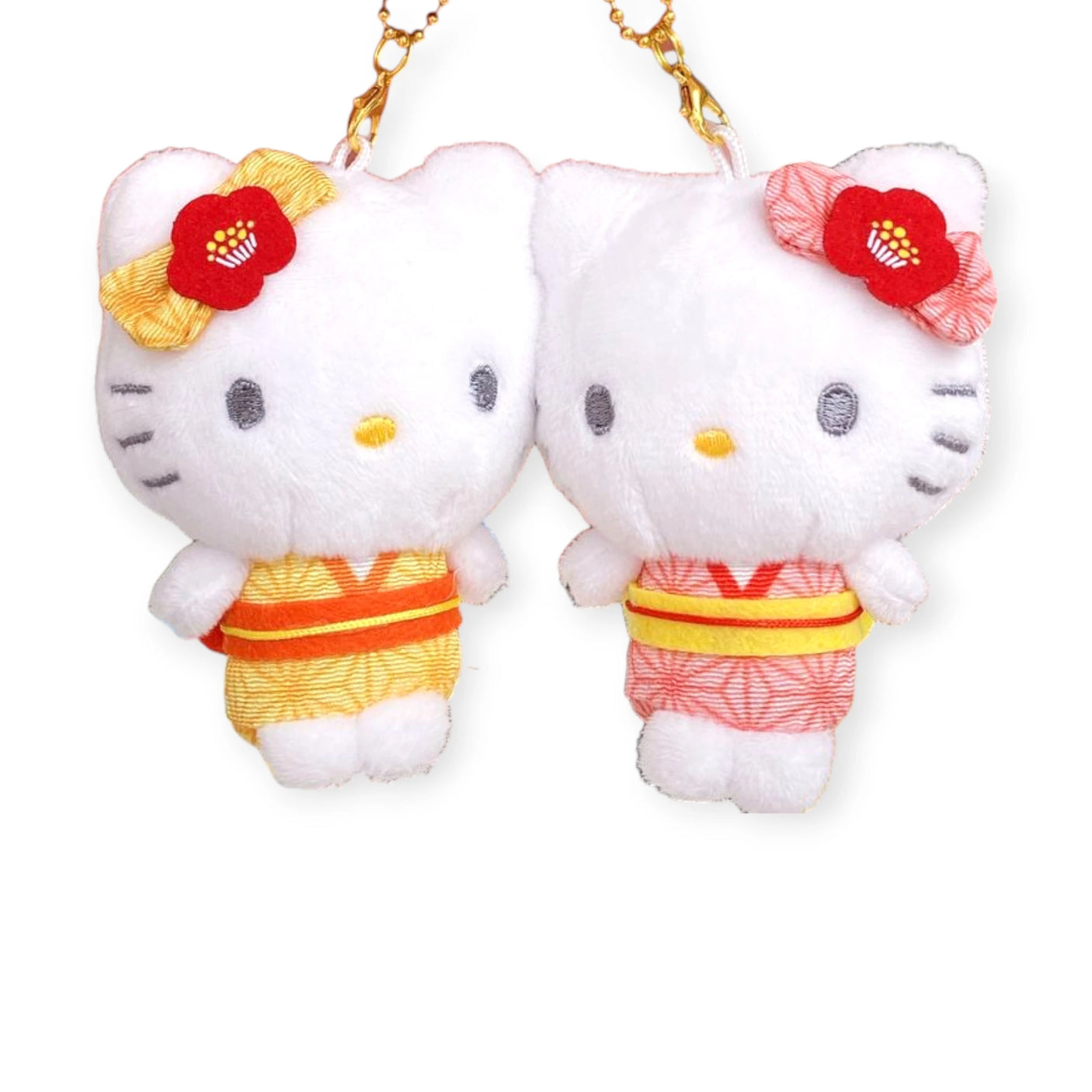 Two Hello Kitty plush toys wearing yellow and red yukatas, each with a red flower on the left ear, hang from Twin BFF Keychains, ideal for sharing with your best friend.