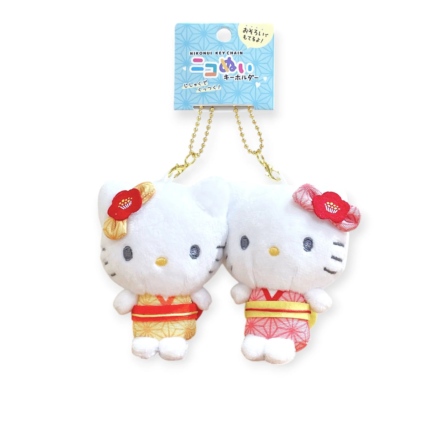 The Hello Kitty - Twin BFF Keychains feature two plush toys with cat-like features in kimonos and floral headpieces, connected by a golden chain. Ideal for friendship lovers who appreciate style, this set embodies the charm of traditional Hello Kitty flair.