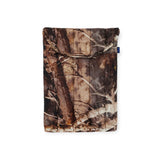 The Baggu Puffy Laptop Sleeve 13"/14", by Baggu, is an eco-friendly fabric pouch that features a forest camouflage pattern with tree branches and bark textures.