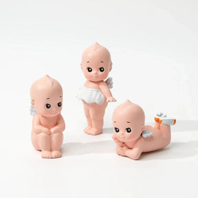 Set of four baby dolls with nude-pink bodies and white diapers, posing