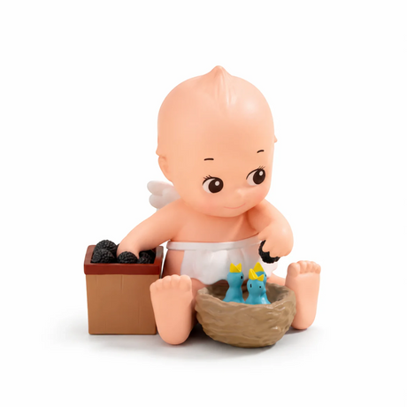 Kewpie blind box figure sitting in a brown box with small blue animal figurine