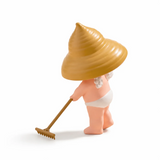 Kewpie blind box figure standing in white shorts wearing a yellow hat and holding a rake