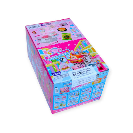 The vibrant pink packaging of the Re-Ment Kirby's Pupupu Market Blind Box, adorned with charming cartoon characters and illustrations of a miniature market, captures the essence of this delightful product. The text is in Japanese, accompanied by detailed images of the Re-Ment minis included in these exciting blind boxes.