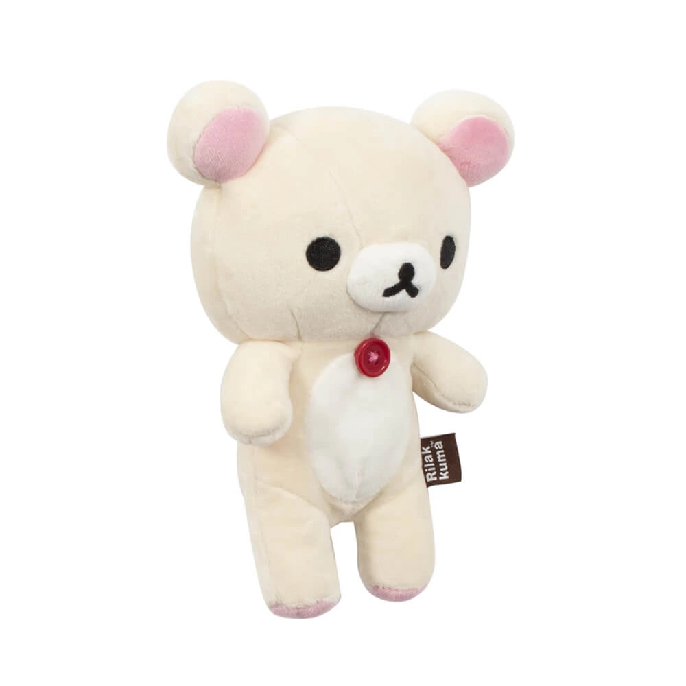 The Korilakkuma Small Plush - 20cm by Rilakkuma features beige fur, pink ears, black eyes, and a red chest button. Standing upright with a "Rilakkuma" side tag, it showcases premium softness and playful charm.