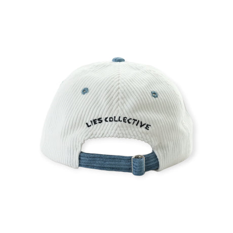 Back view of white corduroy cap with blue adjustable strap and black embroidered Lies Collective text above opening