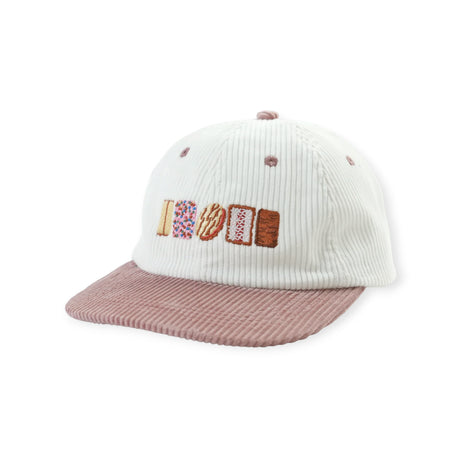 Cream corduroy cap with dusty pink brim featuring embroidered Australian biscuit designs in a row on front panel