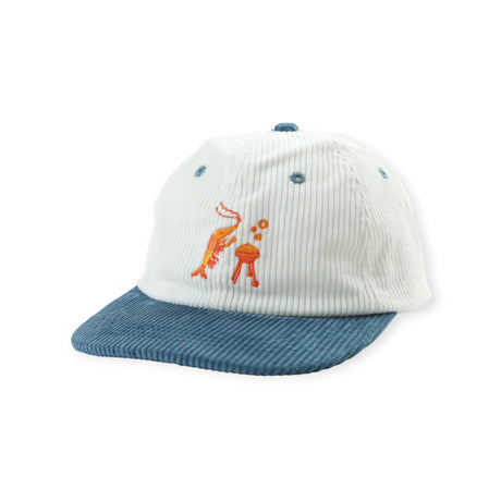 White corduroy cap with blue brim featuring embroidered orange shrimp cooking on red barbecue grill on front panel