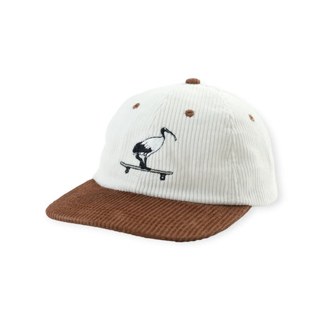 Off-white corduroy baseball cap with brown brim embroidered with black bin chicken on skateboard on front panel
