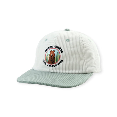 White corduroy cap with light green brim featuring embroidered smiling quokka and Lies Collective text on front panel
