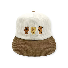 Bicolor corduroy cap with cream knit crown and three bear patches on front
