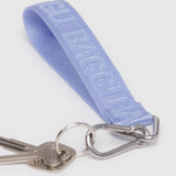 The Baggu Logo Keychain in French Blue, embossed with "CUPRA," stylishly complements two silver keys and a carabiner clip, making for a chic accessory.