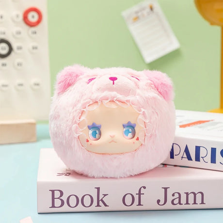 Soft plush Lovely Emma Rua Rua Zoo bag charm in pink bear costume with star-shaped blue eyes on pastel desk background