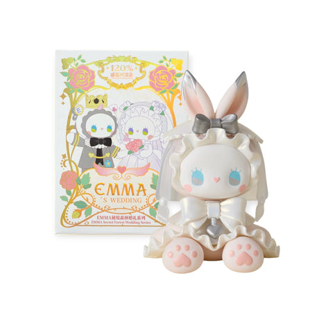 The plush toy, Lucky EMMA - Secret Forest Wedding by Lucky Emma, is a charming bunny-eared bride with a veil sitting in front of a box labeled "Emma's Wedding," part of the exclusive Secret Forest Wedding blind box series capturing the magic of union.