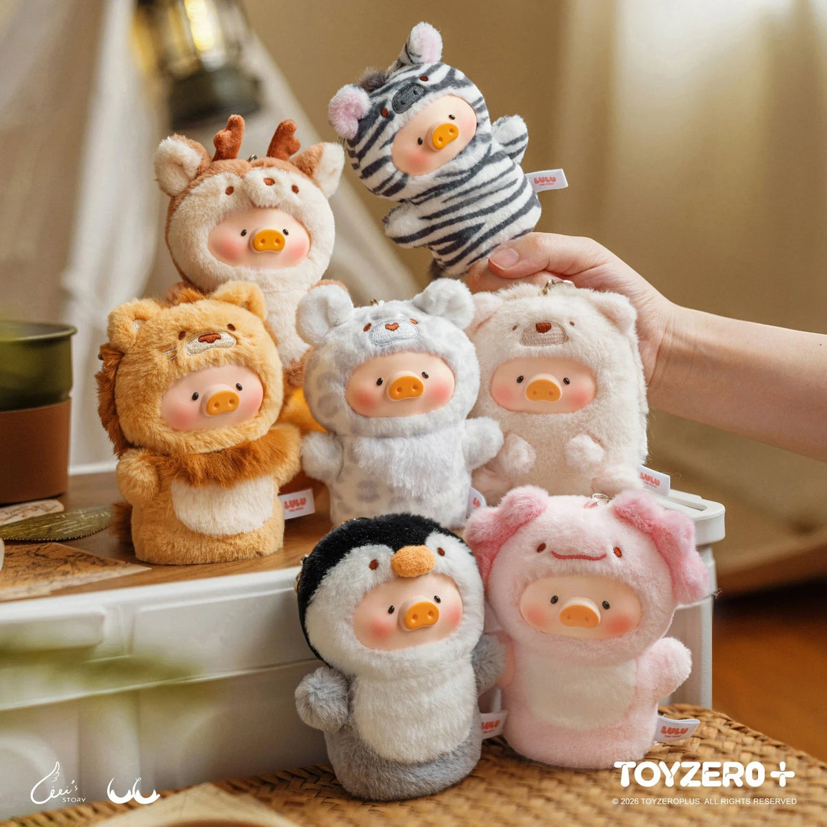 Assorted animal pig plush keychains on display, including zebra and lion styles