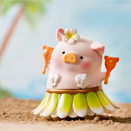 LuLu the Piggy figurine dressed in tropical hula skirt with maracas and flower on head on sandy surface