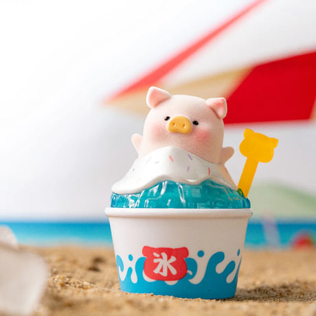Small LuLu the Piggy figurine in beach-themed shaved ice cup with colorful sprinkles on sandy surface
