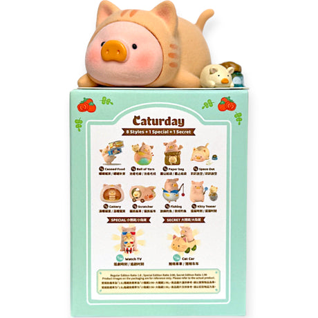 LuLu the Piggy figurine dressed as a cat lying on top of a mint green Caturday Blind Box packaging