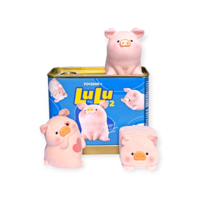 Three soft pink LuLu the Piggy collectible figures with a blue limited edition spam can packaging