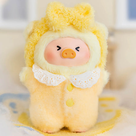 Dreaming Wonderland LuLu Piggy plush keychain in fluffy yellow pajamas with lace collar and sleepy expression on soft surface