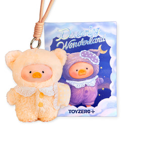 Plush keychain featuring a small pig in a fuzzy peach outfit with lace collar in front of a nighttime illustrated card