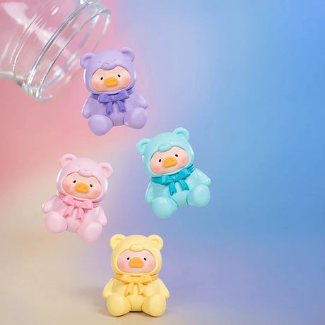 Four pastel LuLu The Piggy figures in bear costumes tumble from a glass jar, resembling surprise collectibles from the LuLu The Piggy - Mini Teddy Blind Bag series, set against a gradient blue and pink background.