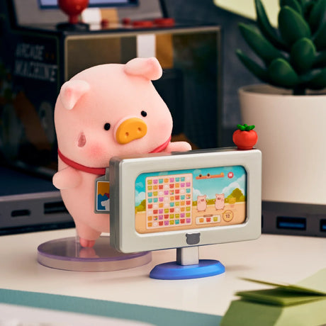 Piggy blind box figure standing at a computer monitor with a colorful task screen