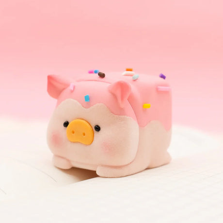 LuLu the Piggy Original Series 2 figure 5 with chocolate-dipped pink frosting and colorful sprinkles on white grid paper background