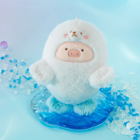 The LuLu The Piggy - Baby Seal LuLu Plush Keychain features a round, white seal with a bear face and pink cheeks standing on blue ice, making it the perfect cute keychain for any ocean-themed adventure.