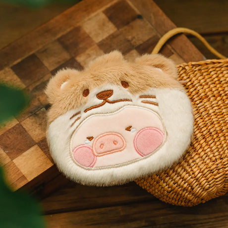 Close-up of LuLu The Piggy Animal Party Pouch in otter design resting on wooden board and wicker basket, gallery 1