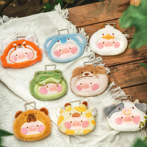 Set of eight LuLu The Piggy Animal Party Pouch Blind Boxes in various animal designs on a wooden surface with fabric underneath