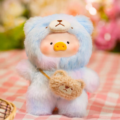 Light blue plush piggy pal holding mini tan satchel, fluffy body and stitched face