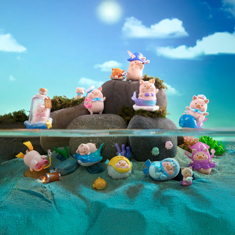 LuLu The Piggy - Ocean Blind Box toys from LuLu The Piggy are dressed as sea creatures, displayed on rocks and sand under a blue sky, with some partly in water, ready for an ocean adventure.
