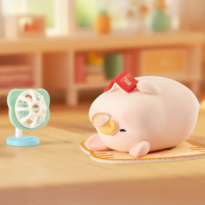 Sitting piggy blind box figure on a mat with small fan accessory