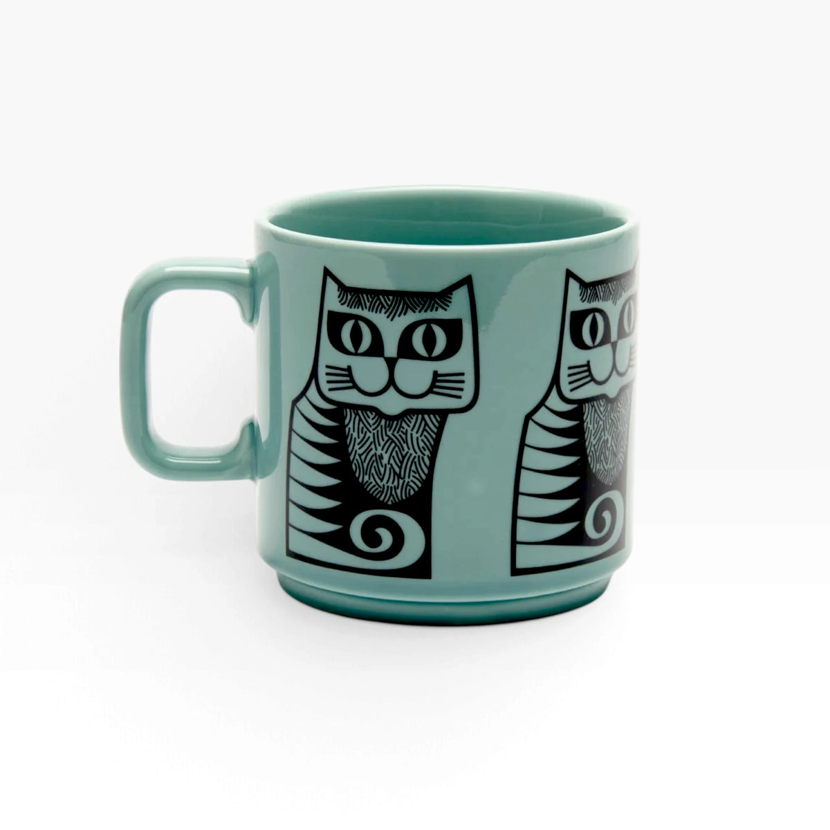 Teal ceramic mug with black cat face print and geometric accents