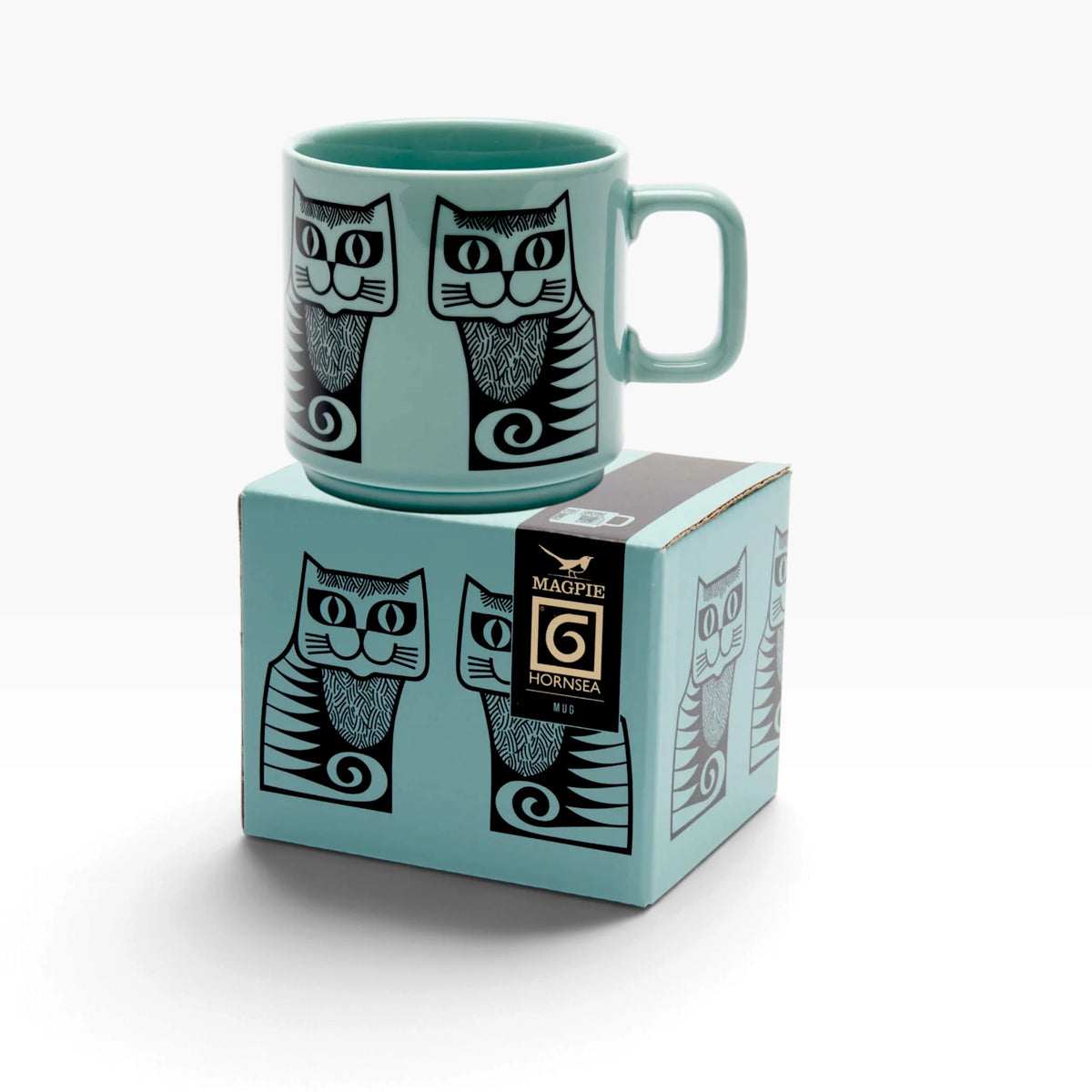 Teal mug with cat print beside matching gift box