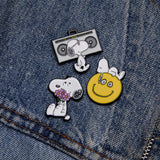Snoopy flowers enamel pin on blue denim, with other small enamel pins
