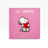 Snoopy love heart enamel pin on PEANUTS card, white dog holding a red heart