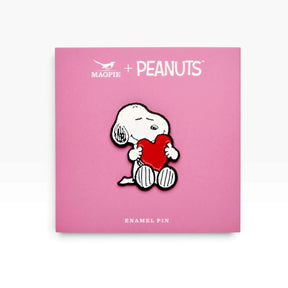 Snoopy love heart enamel pin on PEANUTS card, white dog holding a red heart