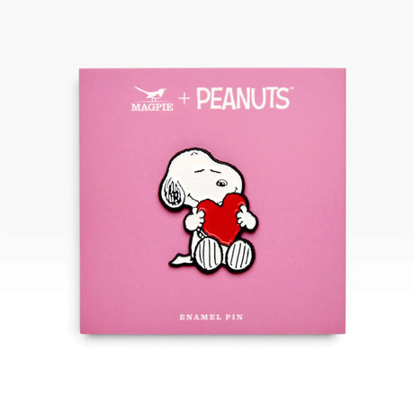 Snoopy love heart enamel pin on PEANUTS card, white dog holding a red heart