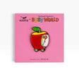 Enamel pin of red apple on pink Richard Scarry's Busy World card