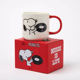 Snoopy ceramic mug with red handle, featuring Snoopy and a vinyl record graphic