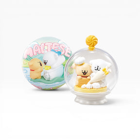 Miniature glass globe figurine with dog and bunny in cream outfits on a base