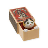 A delightful cat figurine peeks out from an open matchbox, featuring a vintage label design, exquisitely embodying the whimsy of a Kitan Club Cat in a Matchbox Blind Box.