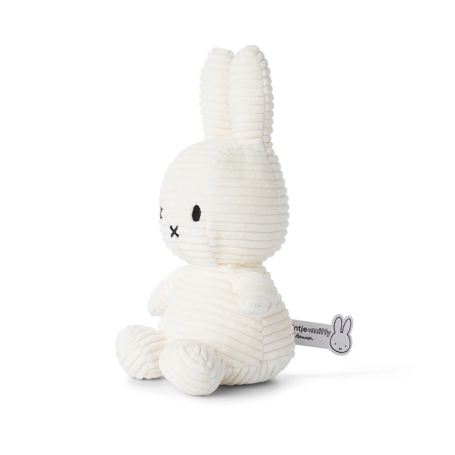 The Miffy Bunny Plush Corduroy - White 23cm, from the Miffy brand, is a delightful toy rabbit featuring a charming ribbed corduroy texture. It sits upright with its long ears and has a small black "X" for a mouth.